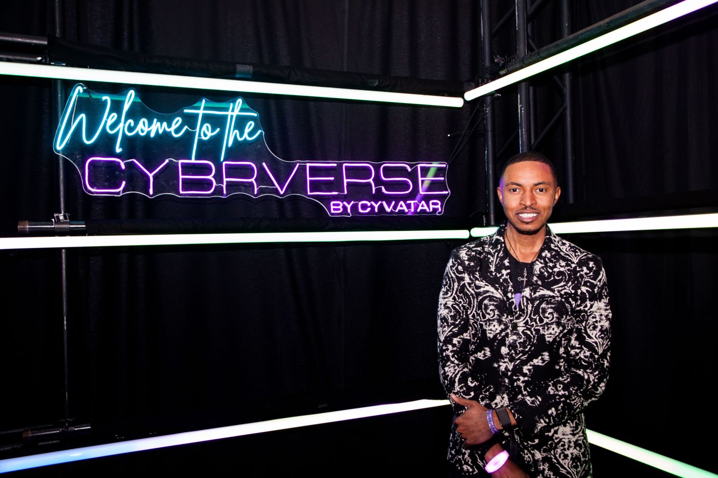 Corey White under the Welcome to the Cybrverse sign